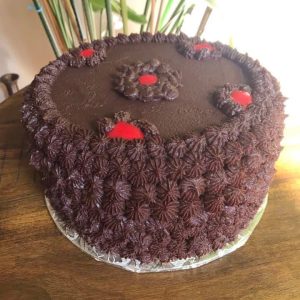 Rich chocolate cake made with pure cocoa and infused coffee moist layered bakery cake topped with smooth chocolate buttercream frosting