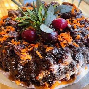 Moist carrot cake made with freshly grated carrots warm spices and smooth cream cheese frosting rich bakery dessert with optional nuts and raisins
