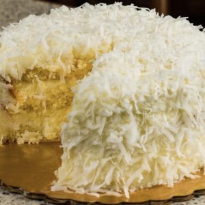 Moist coconut cake made with fresh coconut milk juice and grated coconut flakes soft tropical bakery dessert with rich coconut flavor