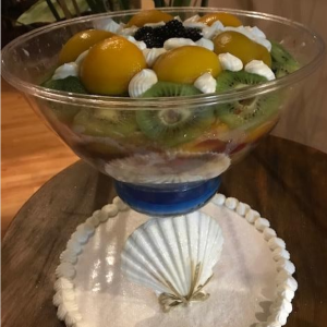 Chipolata creamy dessert layered with custard sponge cake and fresh fruits served as a rich bakery style sweet dish